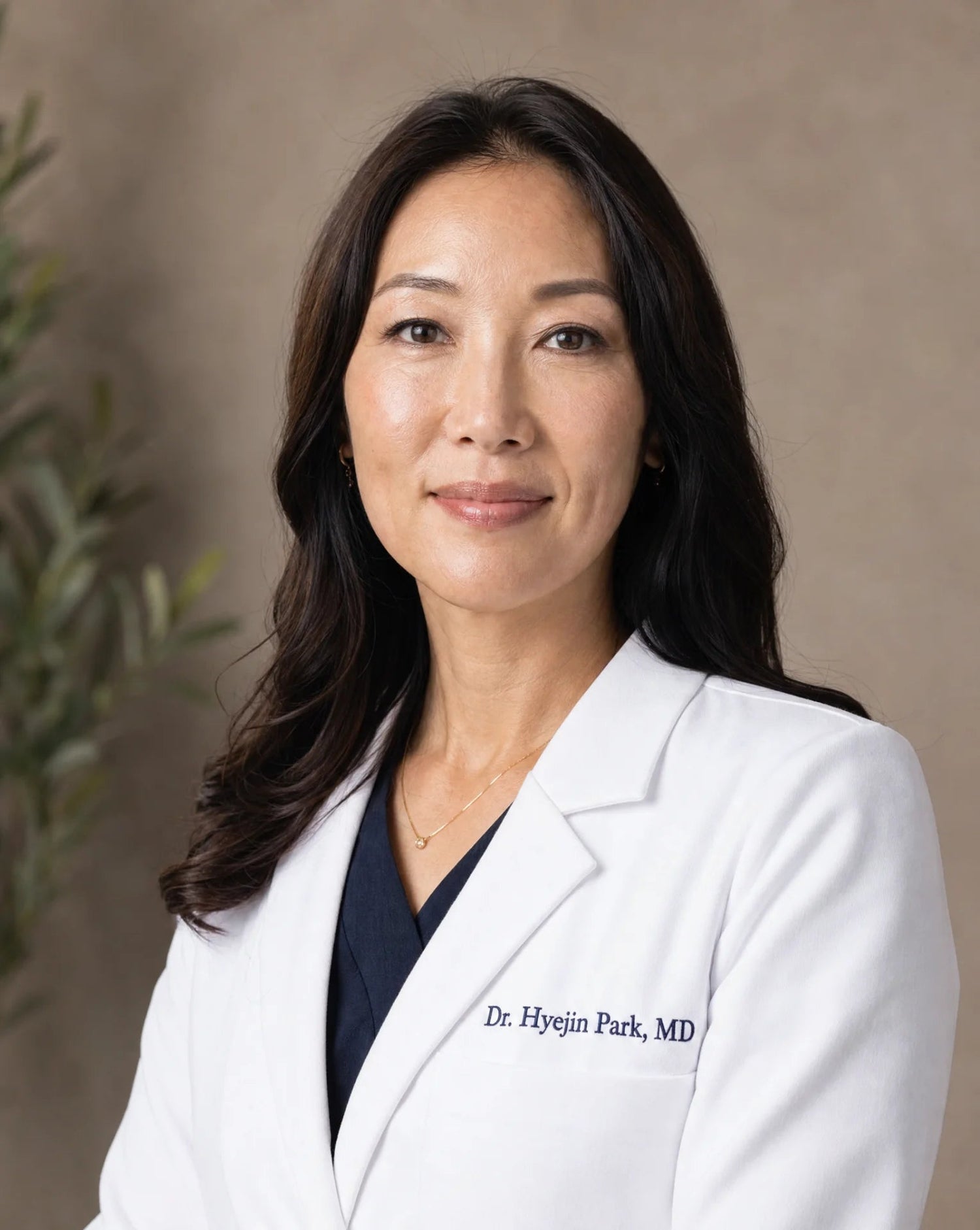 Dr. Hyejin Park MD in a white lab coat posing for a professional portrait in front of a neutral background